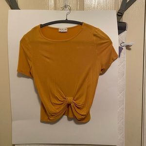 mustard yellow cropped shirt/tie in front